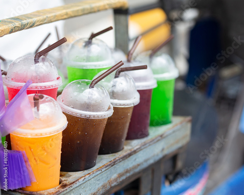 Colorful cold drinks in plastic cups photo