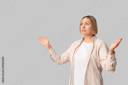 Adult woman outstretching hands on white background. Praying concept