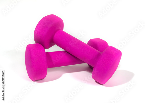 A pair of pink dumbbells for sports and fitness at the gym. Isolated in white bacground.