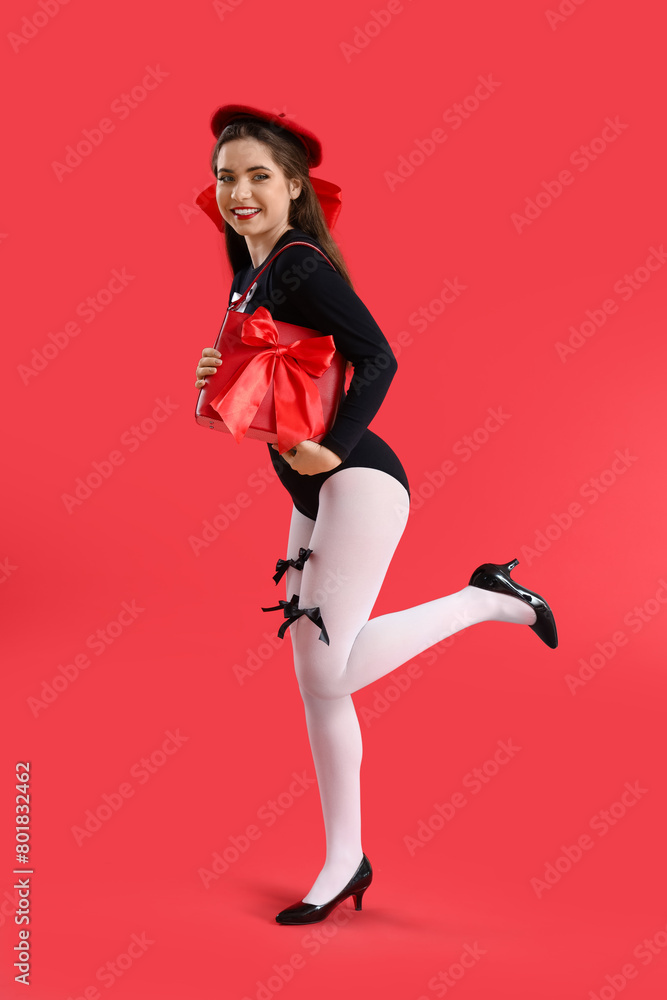 Stylish young woman with bows and bag on red background Stylish young woman with bows and bag on red background