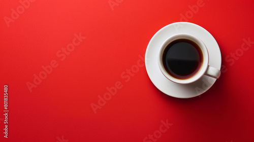 A White Ceramic Cup Filled with Black Coffee on a Bright Red Background