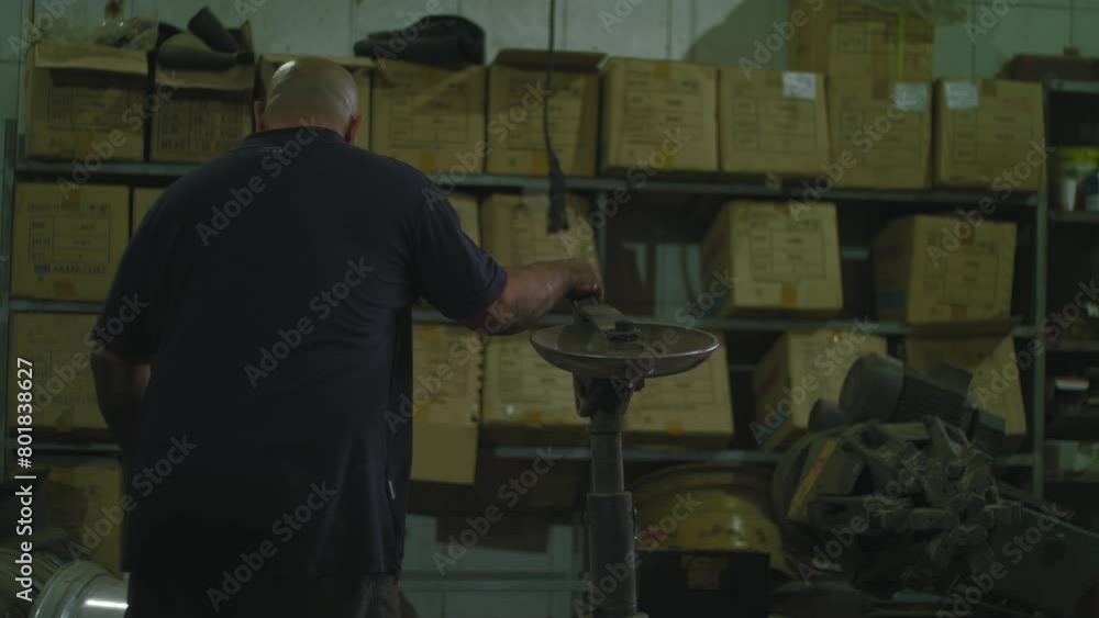 Mechanic pulls a machine towards himself Mechanic pulls a machine towards himself