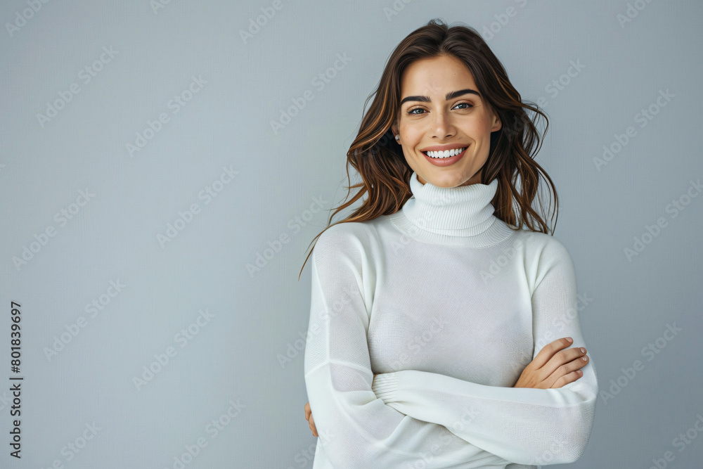 Portrait of happy smiling woman in white turtleneck sweater standing with arms crossed looking at camera over isolated background Portrait of happy smiling woman in white turtleneck sweater standing with arms crossed looking at camera over isolated background