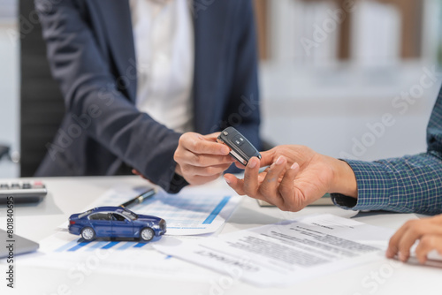 Asian businesswoman specializing in car loan services. Proficient in terms like extended warranty, lease, MSRP, and navigating financing options for customers' automotive needs.