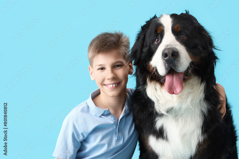 Boy and cute fluffy dog on blue background Boy and cute fluffy dog on blue background