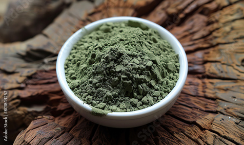 A bowl of vibrant green matcha powder with fresh leaves in the background. Generate AI
