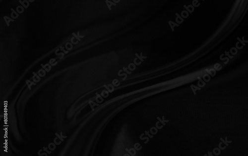 Black gray satin dark fabric texture luxurious shiny that is abstract silk cloth background with patterns soft waves blur beautiful.