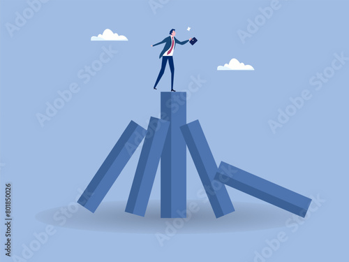 business winner from bankruptcy due to domino effect concept,businessman on stand strong bar graph domino,Fall of big domino cause small dominoes fall down in order.