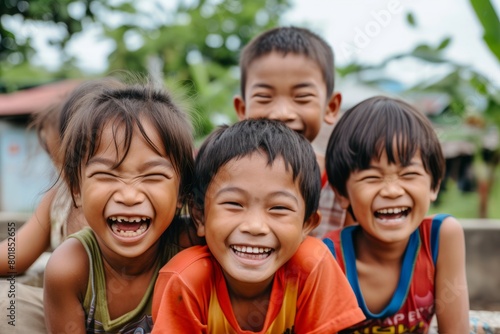 Group of happy asian children smiling and laughing together in the park