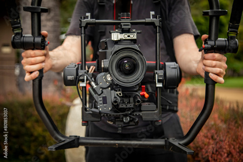 A man wearing a ring grip video camera stabalizer rig