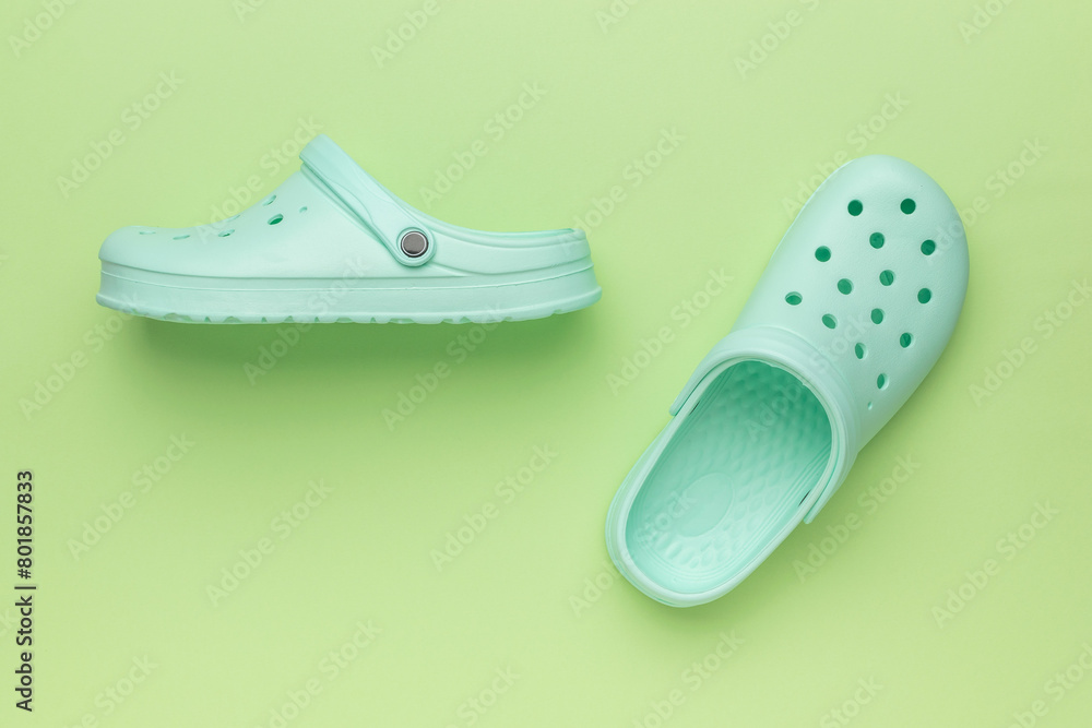 Green women's flip-flops on a green background. Green women's flip-flops on a green background.