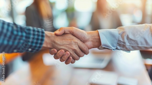 business people shaking hands at a conference table in an office