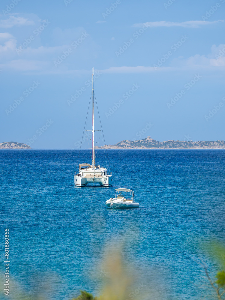 Villasimus, Sardegna. The wonderful bay of Porto Giunco. Sea in shades of turquoise blue. Tourist destination. Sea of Sardinia one of the most beautiful in Italy. Boats off the coast