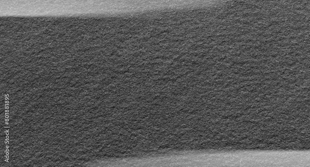 Fototapeta premium Dark gray felt material. Surface of felted fabric texture abstract background in black color with gray vignette. High resolution photo.