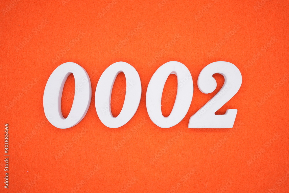 The number 0002 is made from white painted wood placed on a background of orange paper. The number 0002 is made from white painted wood placed on a background of orange paper.