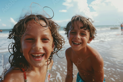 Kids laughing and playing on the beach, Family summer vacation concept © Andrii Fanta