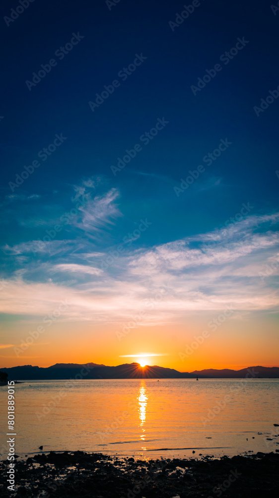 Golden sunset at sea. Portrait. Bonbon Beach, Romblon Island, Philippines Golden sunset at sea. Portrait. Bonbon Beach, Romblon Island, Philippines