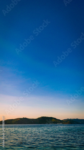 Golden sunset at sea. Portrait. Bonbon Beach, Romblon Island, Philippines © Sydie Vern