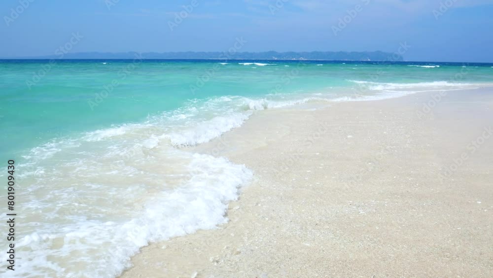 Crystal clear water lapping on tropical beach in the andaman islands. Turquoise water lapping gently on a pristine sandy beach with green jungle in the background Crystal clear water lapping on tropical beach in the andaman islands. Turquoise water lapping gently on a pristine sandy beach with green jungle in the background