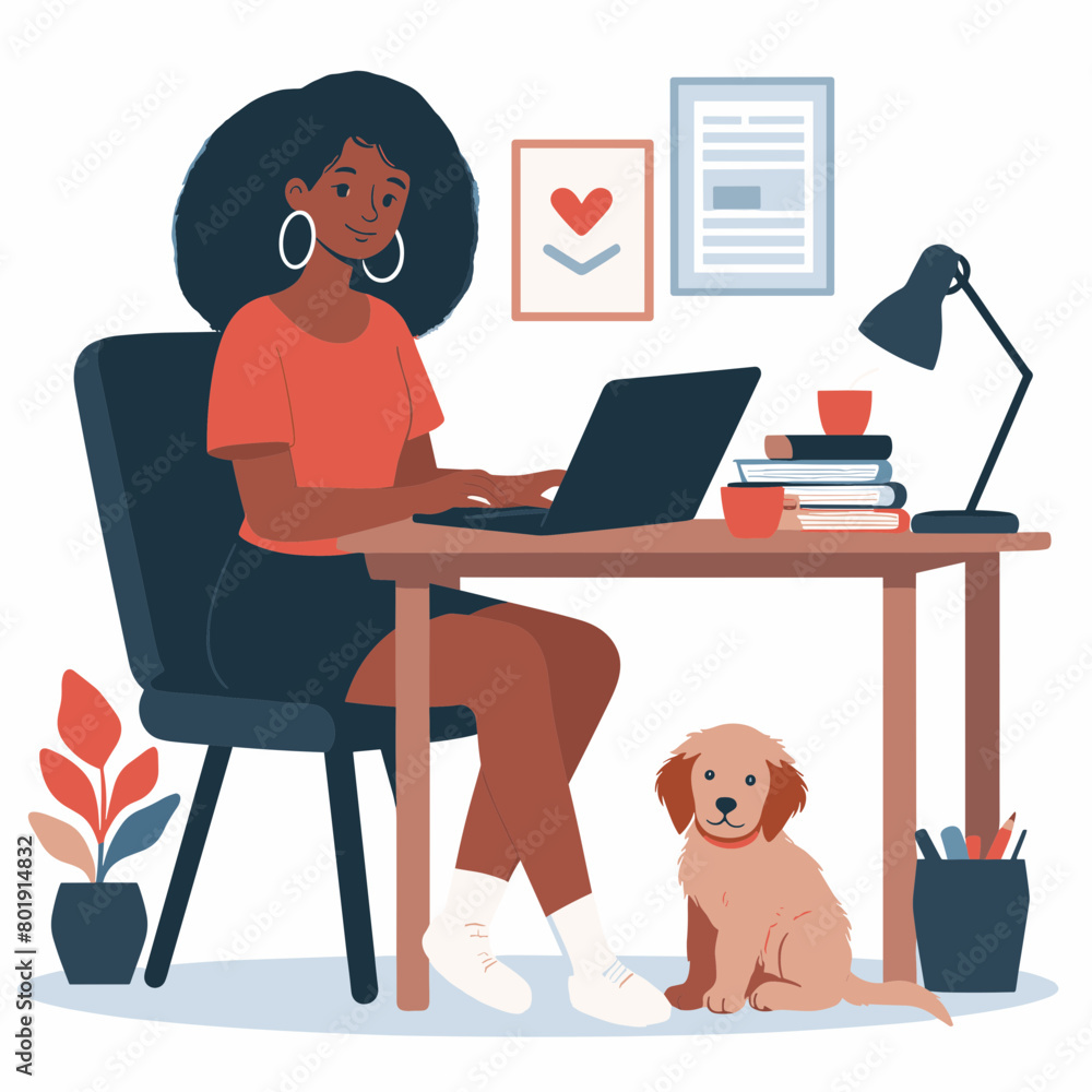 A young woman is sitting at her desk working on her laptop. She has a  sitting next to her.