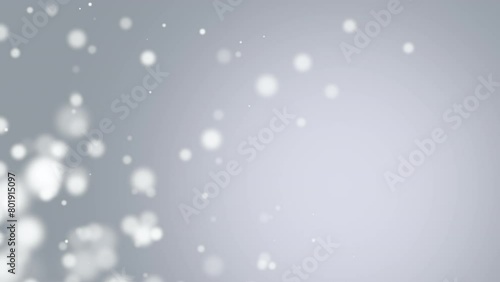 A serene winter wonderland with scattered snowflakes falling gently against a gray sky. The varying sizes and distribution of snowflakes add depth and texture to the scene photo