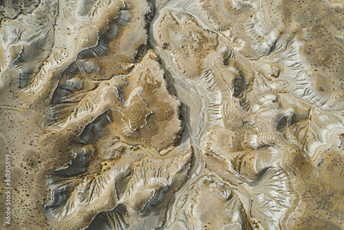 An aerial view of a dried-up riverbed after being washed away by the river, with a vast expanse of land.