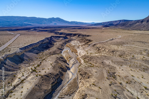 An aerial view of a dried-up riverbed after being washed away by the river, with a vast expanse of land.