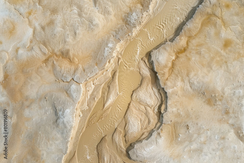 An aerial view of a dried-up riverbed after being washed away by the river, with a vast expanse of land.