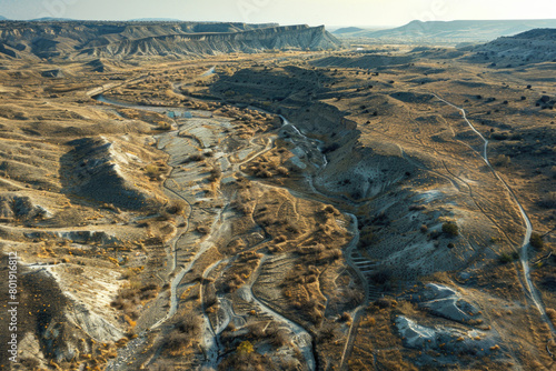 An aerial view of a dried-up riverbed after being washed away by the river, with a vast expanse of land.