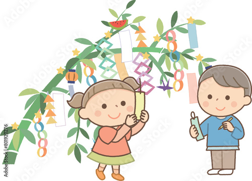 七夕飾りをする男の子と女の子