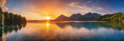 panorama of a serene lake at sunset with a mountain range in the background. photo