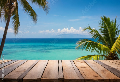 Top of wood table with seascape and palm tree, blur bokeh light of calm sea and sky at tropical beach background