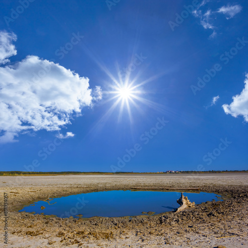 Canvastavla small lake among dry saline land under a sparkle sun