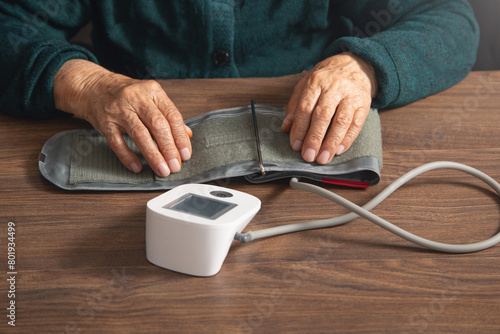Measuring blood pressure of elderly woman at home. © andranik123