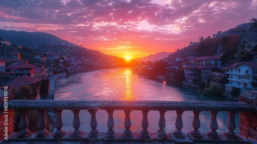 Berat, Albania, as the sun sets over the river, casting vibrant colors across the sky and the quaint historic town. photo