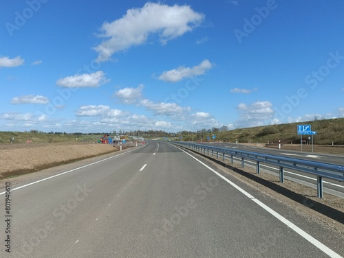 Road under construction in Motiekaicio street. New road in Siaulai. Unfinished road in suburbs. Fields at side. Tiesiama gatve Motiekaicio gatveje Siauliuose.