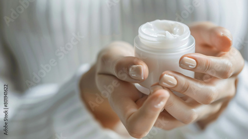 Young woman applying hand cream closeup
