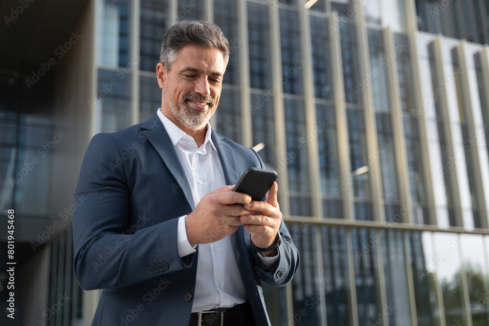 © Stock 4 You - Successful mature hispanic senior business man using smartphone cellphone financial application. Indian or latin confident middle age male entrepreneur businessman holding mobile cell phone for invest