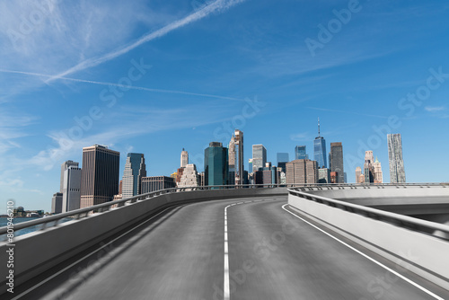 Empty urban asphalt road exterior with city buildings background. New modern highway concrete construction. Concept of way to success. Transportation logistic industry fast delivery. New York. USA.