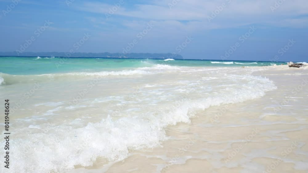 Crystal clear water lapping on tropical beach in the andaman islands. Turquoise water lapping gently on a pristine sandy beach with green jungle in the background Crystal clear water lapping on tropical beach in the andaman islands. Turquoise water lapping gently on a pristine sandy beach with green jungle in the background