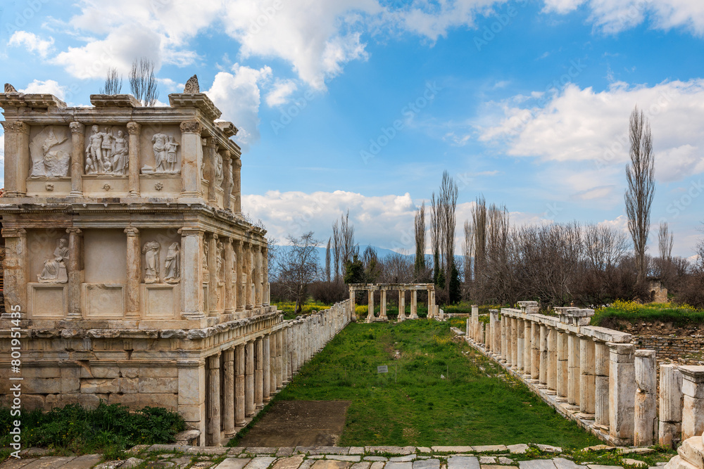 The Sebasteion, a grand structure adorned with detailed reliefs, stands alongside a long colonnade in the historical site of Aphrodisias.