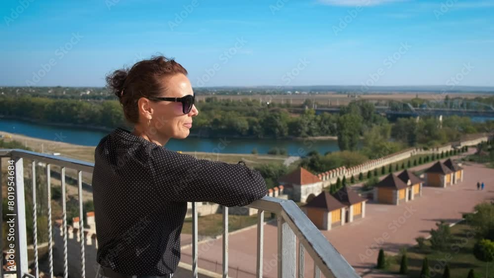 Female enjoy city fortress. A view of nice and smiling female against old fortress place in the sun light. Female enjoy city fortress. A view of nice and smiling female against old fortress place in the sun light.