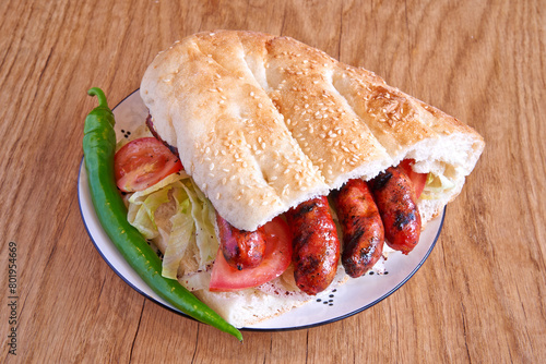 Obraz na płótnie Merguez kebab sandwich on decorated plate on wooden textured table w salonie