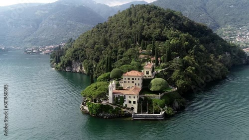 Aerial drone view arriving at Villa del Balbianello is a mansion in the comune of Lenno province of Como and is famous for its elaborate terraced gardens at this moment a popular visit for tourists 4k photo