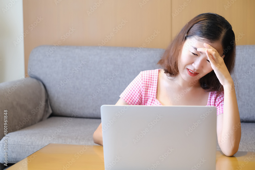 Asia woman headache because playing or working with laptop, work form home Asia woman headache because playing or working with laptop, work form home