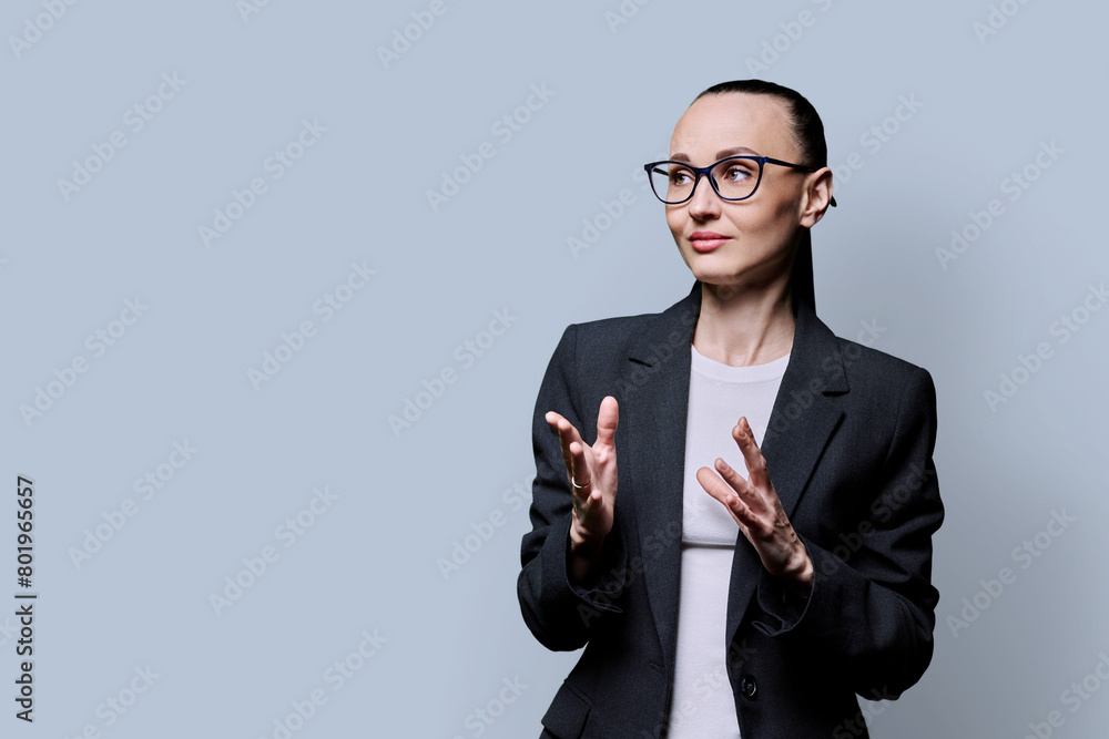 Portrait of thinking serious confident business woman , on grey studio background Portrait of thinking serious confident business woman , on grey studio background