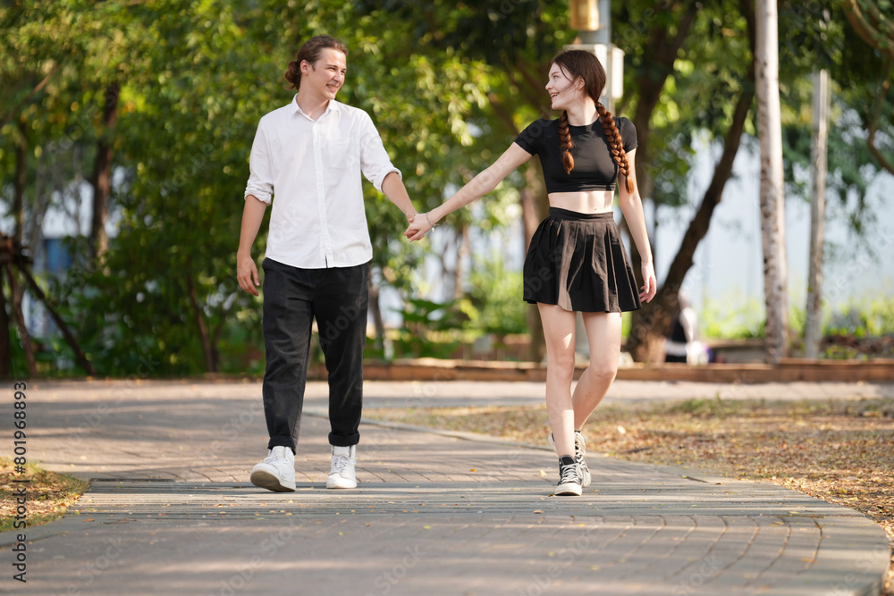 Beautiful young couple outdoors in the park. Portraits of lovers. Autumn. Spring. Holiday Valentine's Day. Beautiful young couple outdoors in the park. Portraits of lovers. Autumn. Spring. Holiday Valentine's Day.