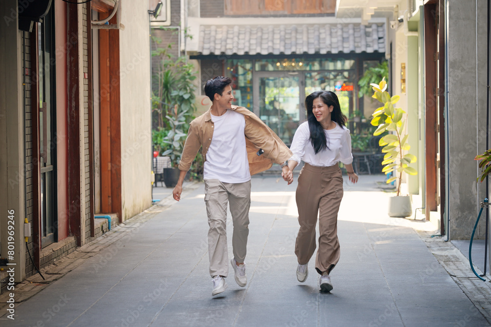 Naklejka premium Beautiful young couple outdoors in the park. Portraits of lovers. Autumn. Spring. Holiday Valentine's Day.