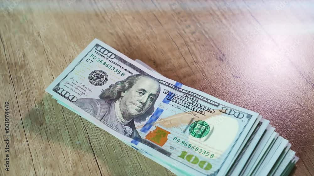 American 100 dollar bills banknote fall on the table. A big stack of money is dropped. Concept of finance and money payment.