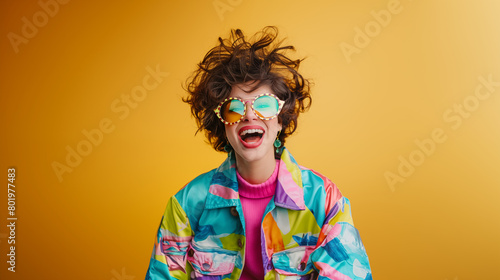 Very happy woman wearing colorful clothes and big glasses celebrating and smiling on a plain background